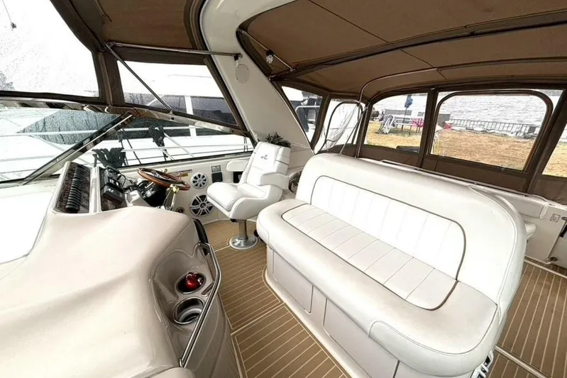  Yacht Photos Pics Interior of 1998 Sea Ray 400 Sundancer yacht with white seating and helm station.