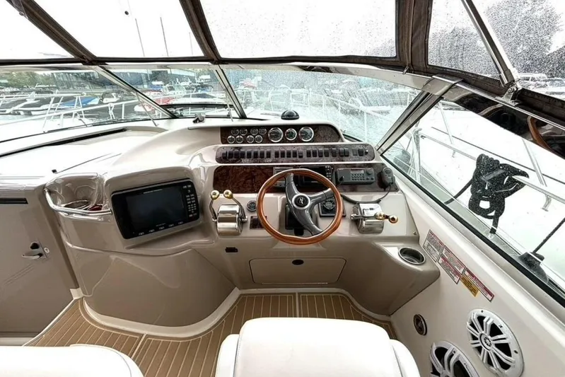  Yacht Photos Pics Cockpit of 1998 Sea Ray 400 Sundancer with steering wheel and navigation controls.