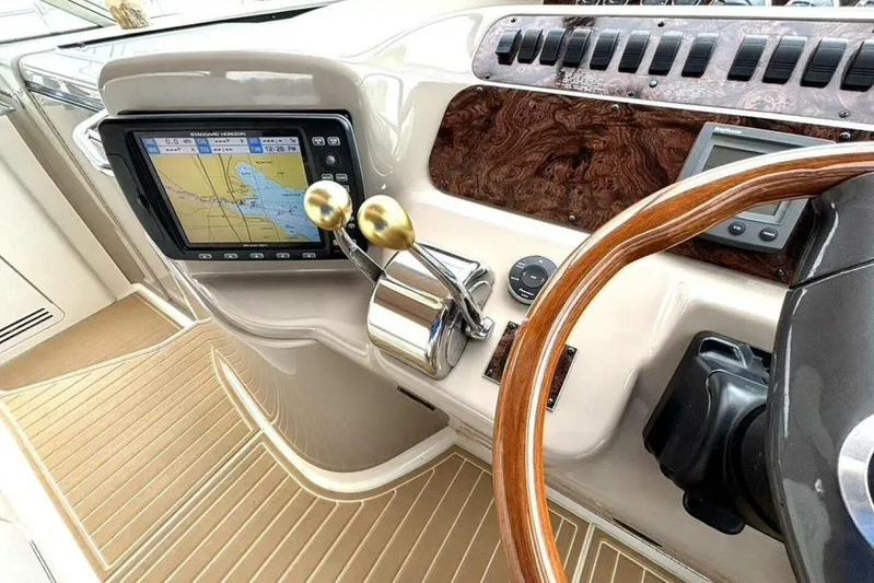  Yacht Photos Pics 1998 Sea Ray 400 Sundancer helm with GPS, wooden steering wheel, and control panel.