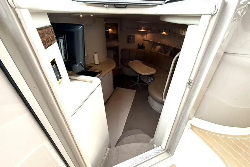  Yacht Photos Pics Interior view of 1998 Sea Ray 400 Sundancer yacht, featuring cozy seating and modern amenities.