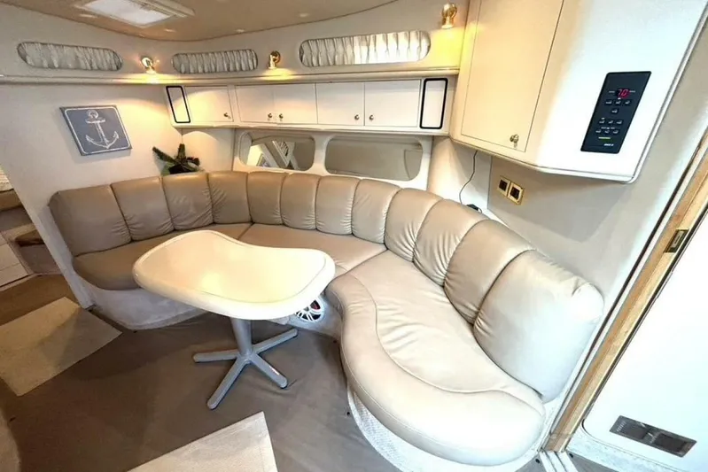  Yacht Photos Pics Interior of 1998 Sea Ray 400 Sundancer yacht with curved leather seating and table.