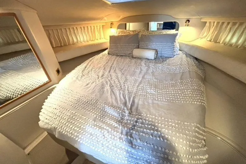  Yacht Photos Pics Cozy bedroom interior of 1998 Sea Ray 400 Sundancer yacht with elegant bedding.
