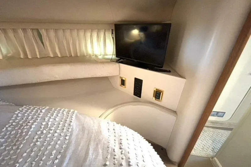  Yacht Photos Pics Interior cabin of 1998 Sea Ray 400 Sundancer with TV and cozy bedding.