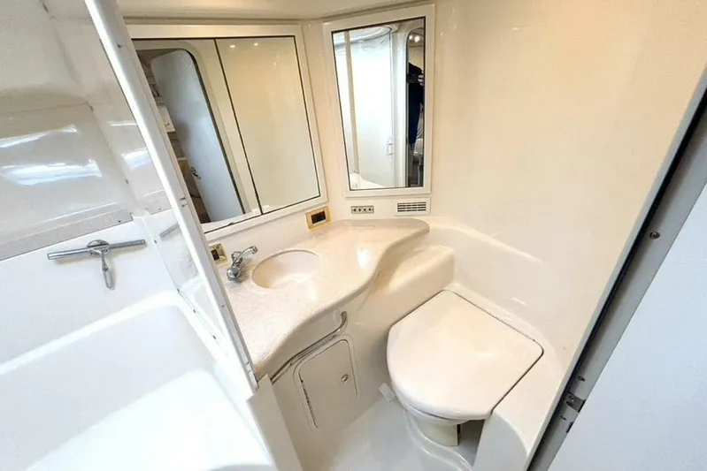  Yacht Photos Pics 1998 Sea Ray 400 Sundancer bathroom with sink, mirror, and toilet.