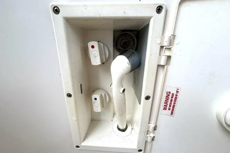  Yacht Photos Pics Boat shower controls on a 1998 Sea Ray 400 Sundancer, featuring hot and cold water knobs.