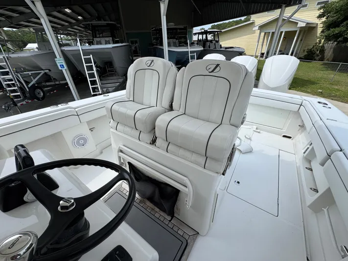  Yacht Photos Pics 2018 Jupiter 34 HFS boat interior with dual captain's chairs and steering wheel.