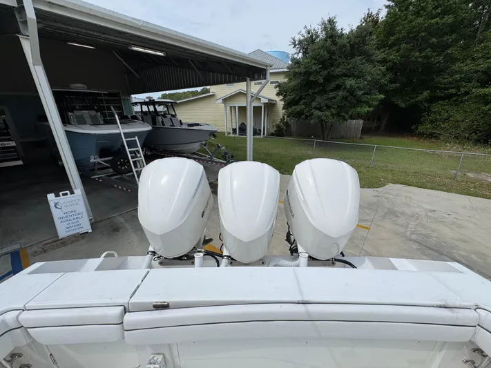  Yacht Photos Pics 2018 Jupiter 34 HFS boat with triple outboard engines in a marina setting.