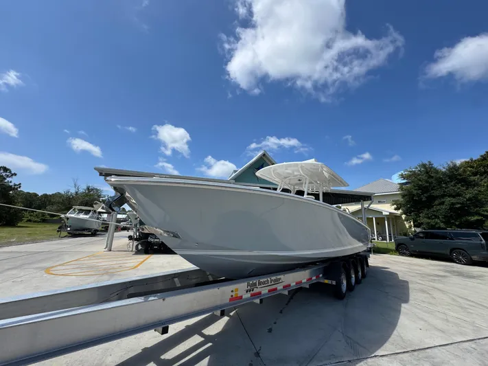  Yacht Photos Pics 2018 Jupiter 34 HFS boat on trailer under blue sky.