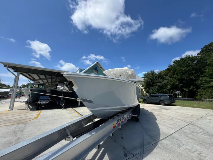  Yacht Photos Pics 2018 Jupiter 34 HFS boat on trailer under clear blue sky.