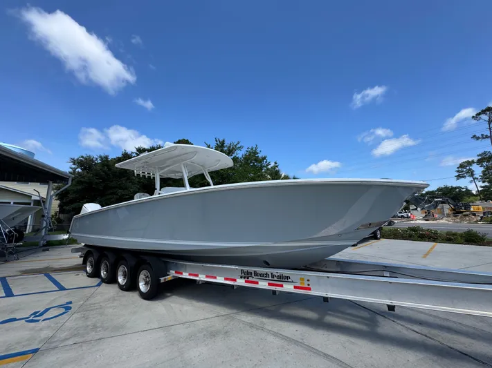  Yacht Photos Pics 2018 Jupiter 34 HFS boat on trailer under clear blue sky.