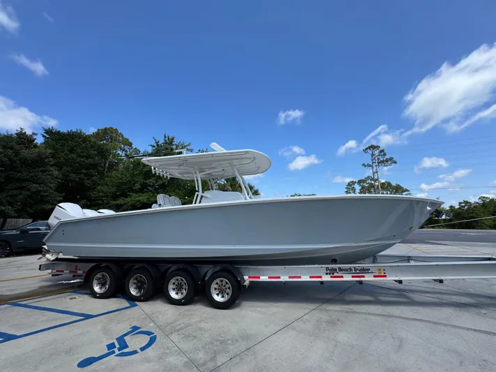  Yacht Photos Pics 2018 Jupiter 34 HFS boat on trailer under clear blue sky.