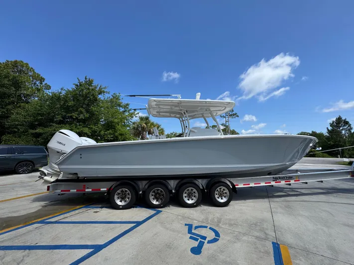  Yacht Photos Pics 2018 Jupiter 34 HFS boat on trailer under clear blue sky.