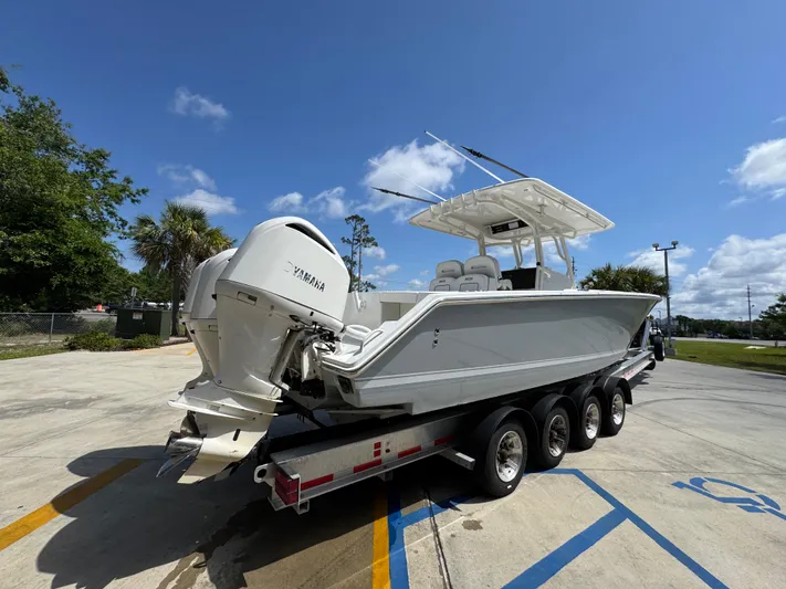  Yacht Photos Pics 2018 Jupiter 34 HFS boat on trailer with Yamaha engine, parked outdoors.