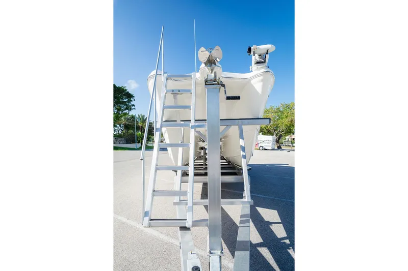  Yacht Photos Pics 2024 World Cat 295 CC boat on trailer with ladder, parked outdoors.