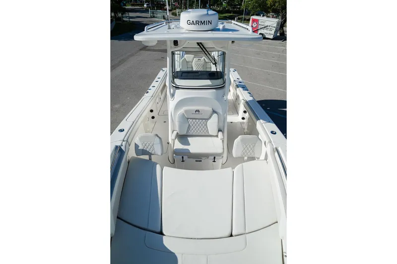  Yacht Photos Pics 2024 World Cat 295 CC boat interior with Garmin equipment, featuring white seating and console.