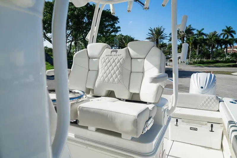 Yacht Photos Pics 2024 World Cat 295 CC boat with luxurious white seating and palm trees in the background.