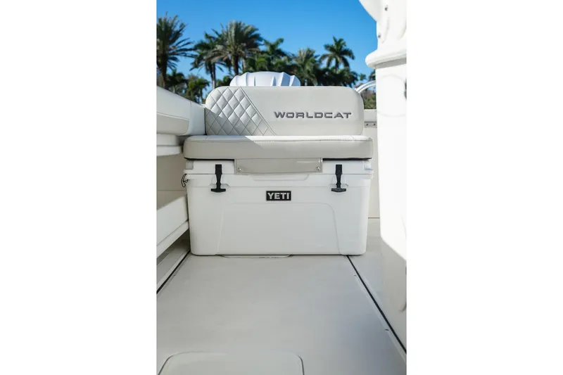  Yacht Photos Pics 2024 World Cat 295 CC boat seat with Yeti cooler, palm trees in background.