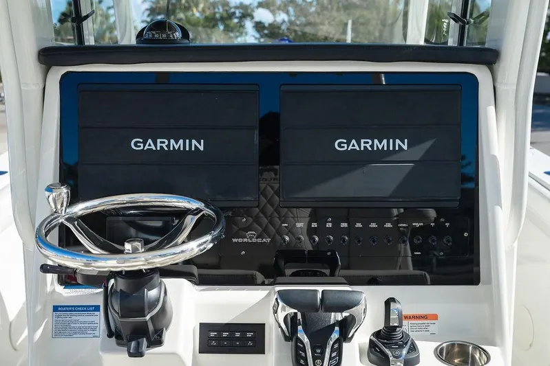 Yacht Photos Pics 2024 World Cat 295 CC dashboard with dual Garmin displays and steering wheel.