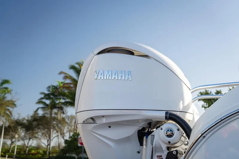  Yacht Photos Pics 2024 World Cat 295 CC with Yamaha outboard motor, palm trees in background.
