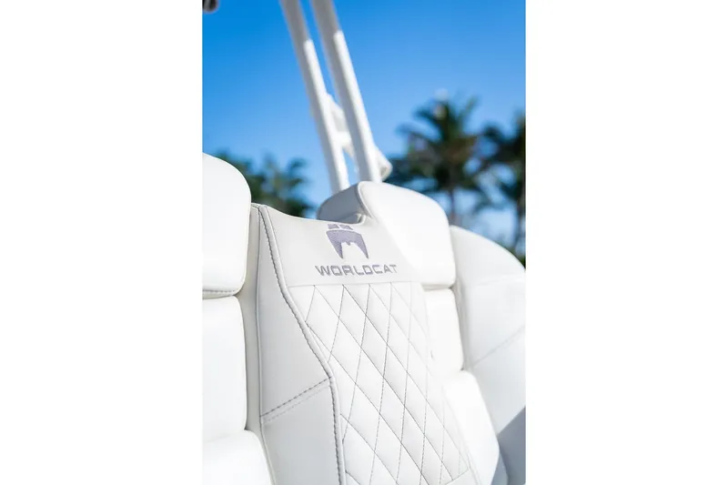  Yacht Photos Pics 2024 World Cat 295 CC boat seat with logo, palm trees in background.