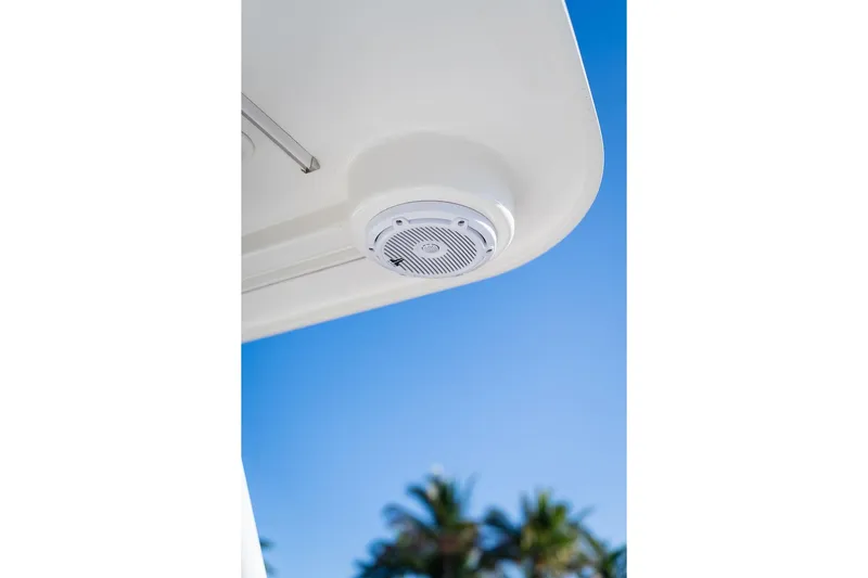  Yacht Photos Pics 2024 World Cat 295 CC boat speaker against clear blue sky and palm trees.