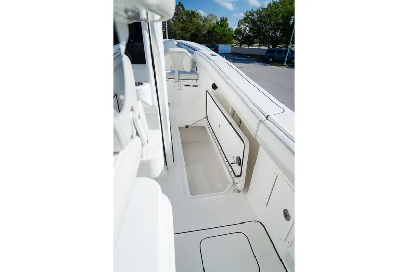  Yacht Photos Pics 2024 World Cat 295 CC boat interior with open storage compartment, showcasing sleek design.