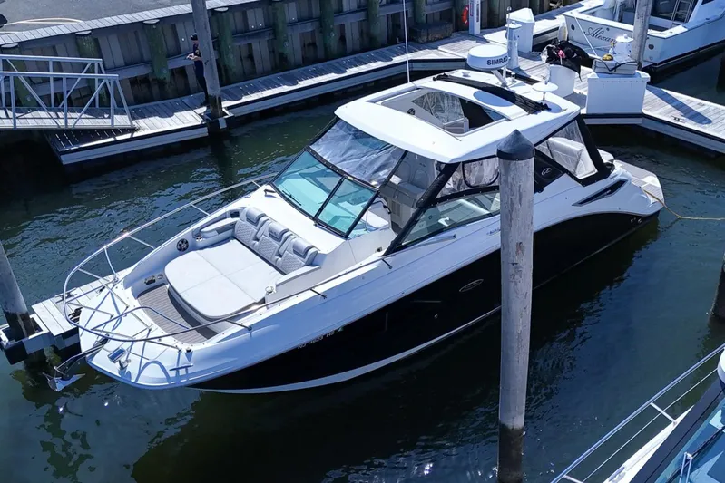  Yacht Photos Pics 2023 Sea Ray Sundancer 320 docked at a marina, showcasing sleek design and luxury features.
