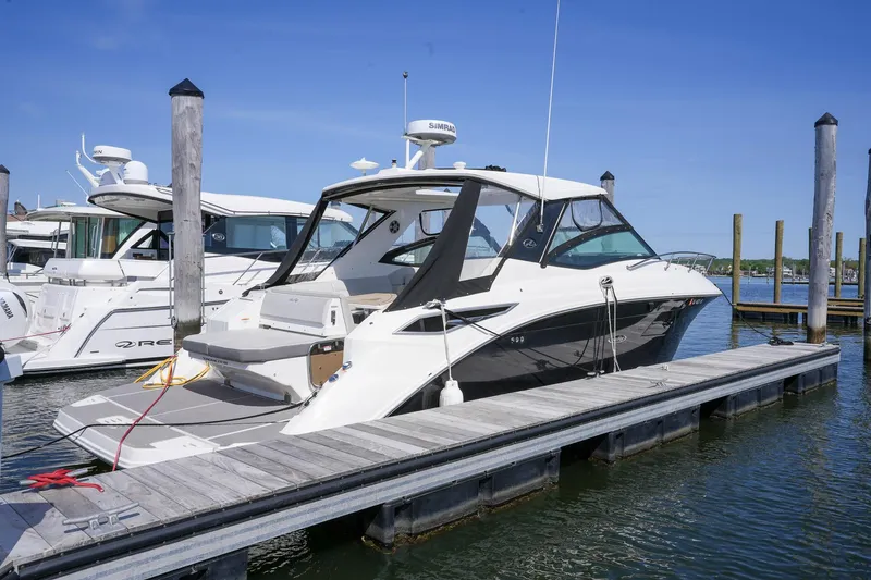  Yacht Photos Pics 2023 Sea Ray Sundancer 320 docked at marina under clear blue sky.