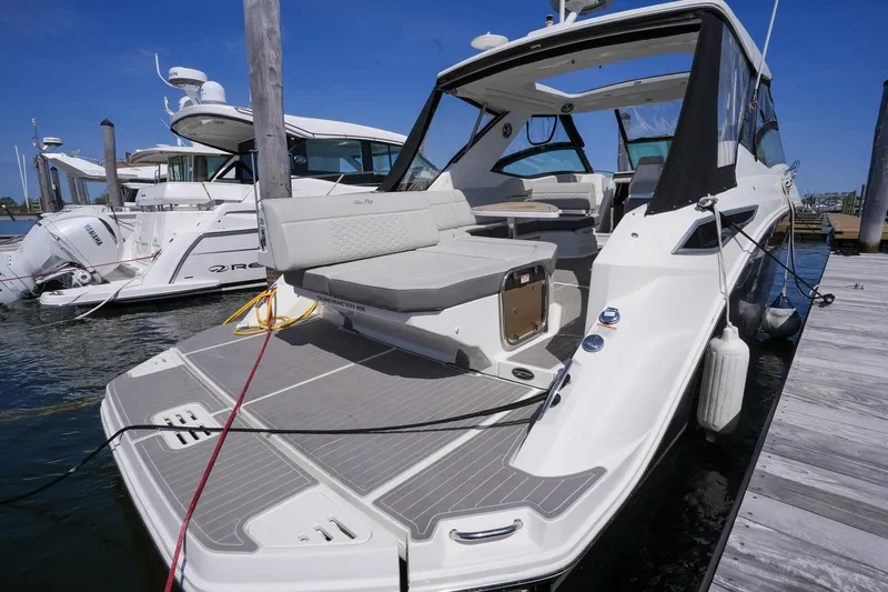  Yacht Photos Pics 2023 Sea Ray Sundancer 320 yacht docked, showcasing sleek design and spacious deck.