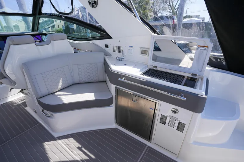  Yacht Photos Pics 2023 Sea Ray Sundancer 320 interior with seating and kitchenette area.