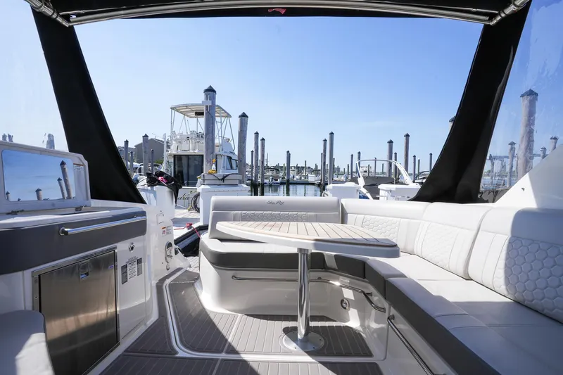  Yacht Photos Pics 2023 Sea Ray Sundancer 320 interior with seating and table, docked at marina.