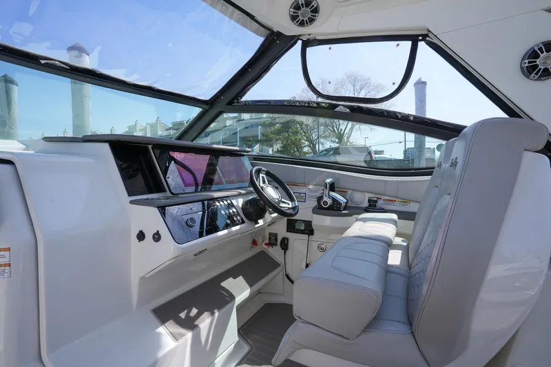  Yacht Photos Pics 2023 Sea Ray Sundancer 320 helm with modern controls and comfortable seating.