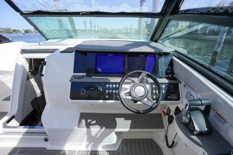  Yacht Photos Pics 2023 Sea Ray Sundancer 320 helm with modern controls and navigation screens.