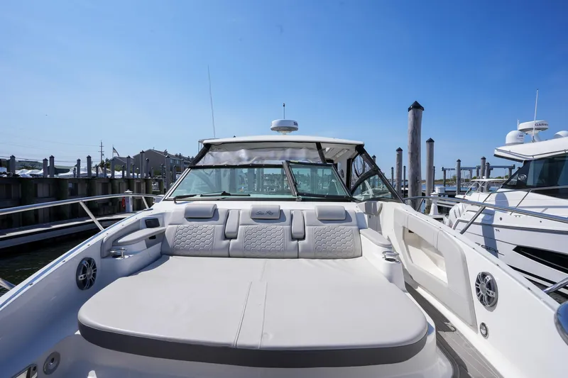 Yacht Photos Pics 2023 Sea Ray Sundancer 320 yacht with spacious deck and luxurious seating at marina.