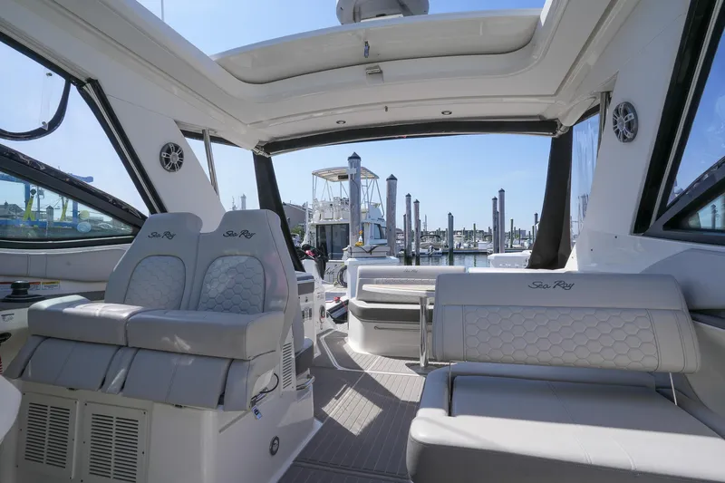 Yacht Photos Pics 2023 Sea Ray Sundancer 320 interior with luxurious seating and marina view.