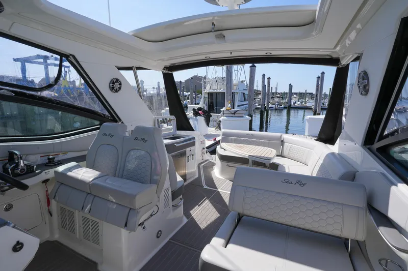 Yacht Photos Pics 2023 Sea Ray Sundancer 320 interior with luxurious seating and marina view.