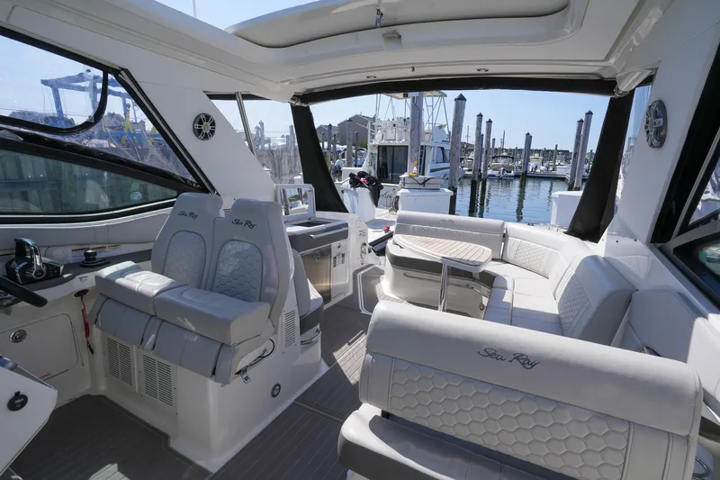  Yacht Photos Pics 2023 Sea Ray Sundancer 320 interior with luxurious seating and marina view.