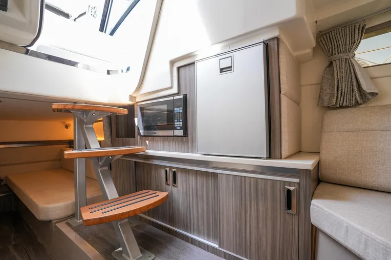  Yacht Photos Pics Interior of 2023 Sea Ray Sundancer 320 yacht with modern wood finish and compact design.