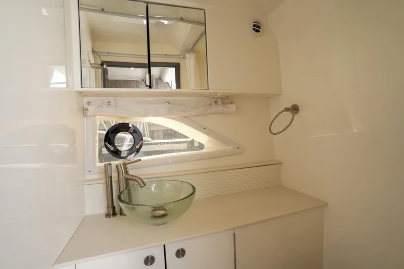  Yacht Photos Pics Modern bathroom interior of 2023 Sea Ray Sundancer 320 yacht with glass sink and mirror.