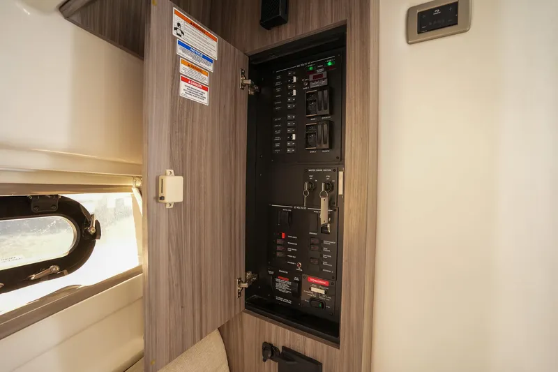  Yacht Photos Pics Electrical panel inside 2023 Sea Ray Sundancer 320 yacht, featuring modern controls and wood finish.