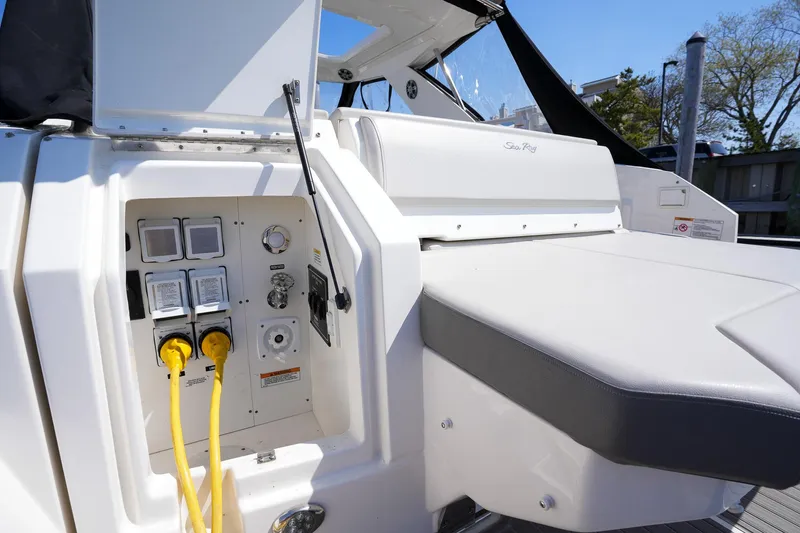  Yacht Photos Pics 2023 Sea Ray Sundancer 320 yacht with electrical panel and seating area.