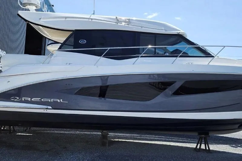  Yacht Photos Pics 2022 Regal 42 XO yacht with sleek design, docked outdoors under clear sky.