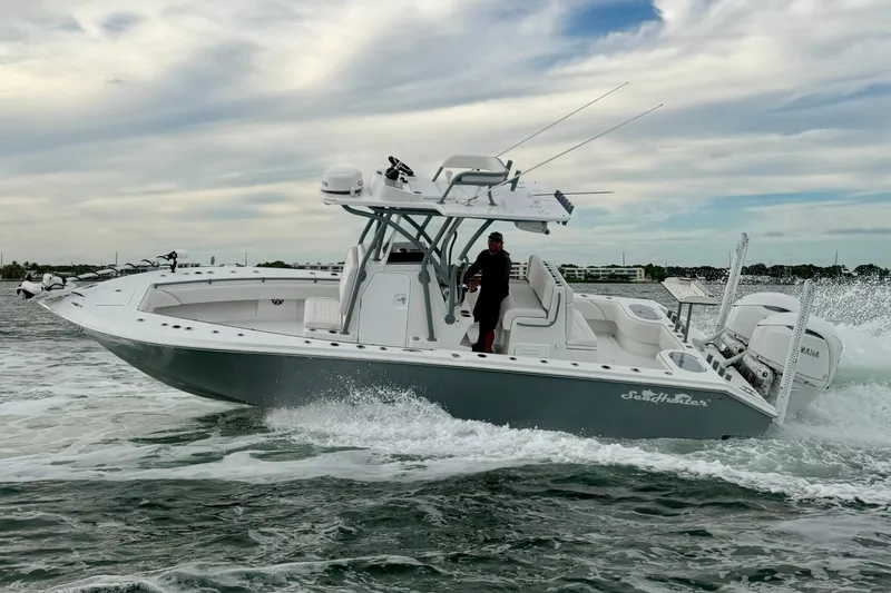  Yacht Photos Pics 2024 SeaHunter 28 Floridian boat cruising on water under a cloudy sky.