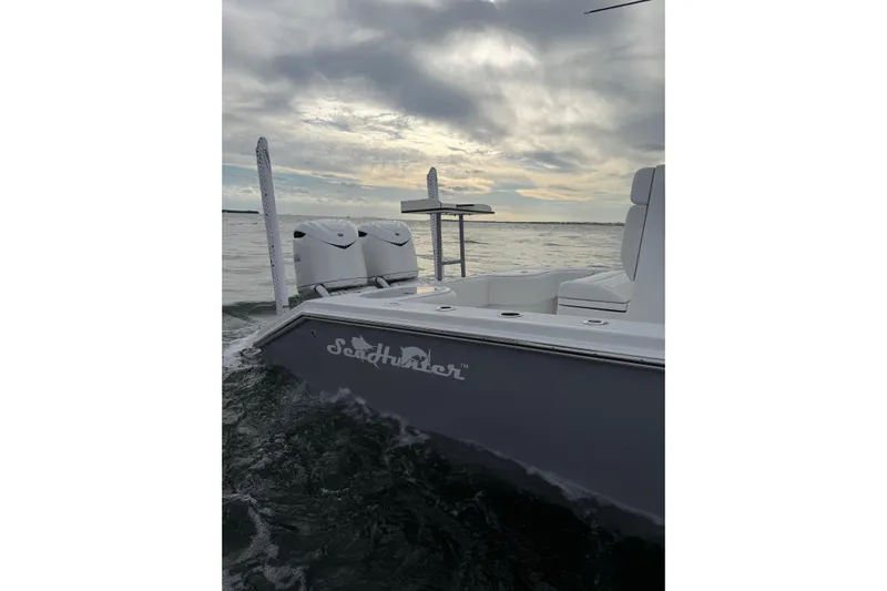  Yacht Photos Pics 2024 SeaHunter 28 Floridian boat on water under cloudy sky.