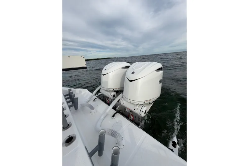  Yacht Photos Pics 2024 SeaHunter 28 Floridian boat with dual outboard engines on open water.