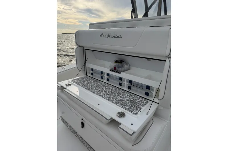  Yacht Photos Pics 2024 SeaHunter 28 Floridian boat with open storage compartment, ocean view in background.