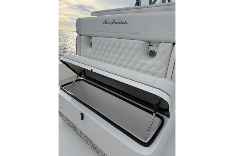  Yacht Photos Pics 2024 SeaHunter 28 Floridian boat with open storage compartment, white quilted seating.