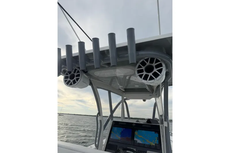  Yacht Photos Pics 2024 SeaHunter 28 Floridian boat console with rod holders and speakers on a calm sea.