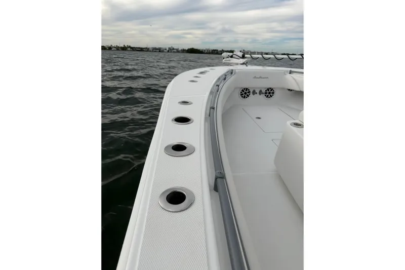  Yacht Photos Pics 2024 SeaHunter 28 Floridian boat deck with rod holders, on calm water.