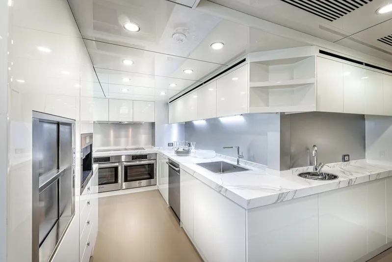Numarine 32xp Yacht Photos Pics Modern kitchen interior on 2026 Numarine 32XP yacht, featuring sleek white cabinetry and stainless steel appliances.